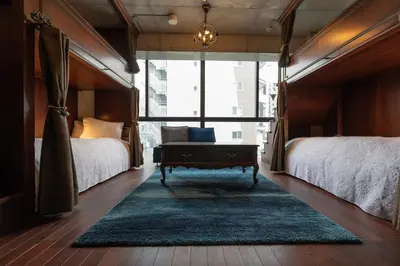 a bedroom with two beds and a coffee table in it at Creare Ryogoku in Tokyo