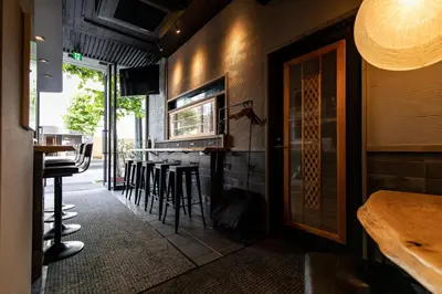 a restaurant with a bar with stools at Creare Ryogoku in Tokyo