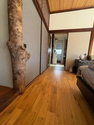 a room with a bed and a tree in it at Kitazawa Cozy House in Tokyo