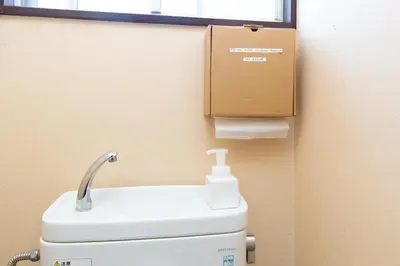 a box sitting on top of a toilet in a bathroom at Kitazawa Cozy House in Tokyo