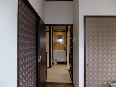 a hallway with a door leading to a bathroom at Kitazawa Cozy House in Tokyo