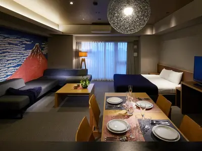 a hotel room with a bed and a dining room at Minn Ueno in Tokyo