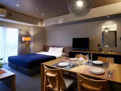 a hotel room with a bed and a dining table at Minn Ueno in Tokyo