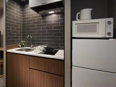 a kitchen with a white refrigerator and a microwave at Minn Ueno in Tokyo