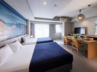 a hotel room with two beds and a desk at Minn Ueno in Tokyo