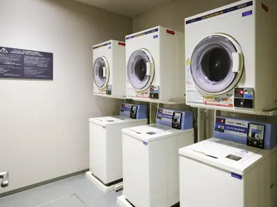 a row of washing machines in a laundry room at Minn Ueno in Tokyo