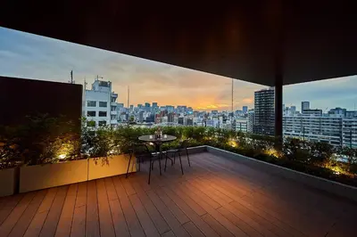 a balcony with a table and a view of a city at The Gate Hotel Ryogoku by Hulic in Tokyo
