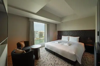 a hotel room with a large bed and a window at The Gate Hotel Ryogoku by Hulic in Tokyo