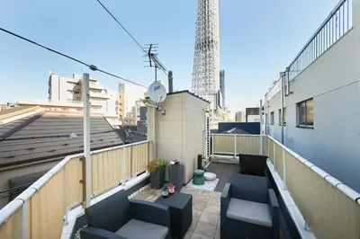 a balcony with two chairs and a table on a building at Touch and Go Azumabashi - Vacation STAY 85085 in Tokyo