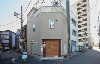 a small building with a wooden door on a street at Touch and Go Azumabashi - Vacation STAY 85085 in Tokyo