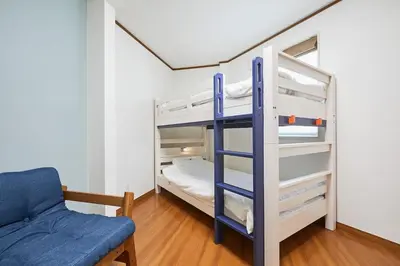 a bunk bed in a room with a bed and a couch at Touch and Go Azumabashi - Vacation STAY 85085 in Tokyo