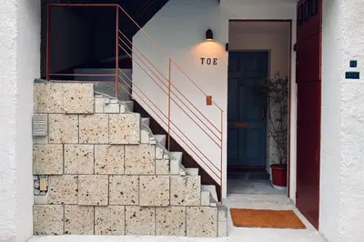 a set of stairs leading up to a door at TOE LIBRARY Tokyo Asakusa in Tokyo