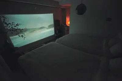 a bedroom with two beds and a flat screen tv at TOE LIBRARY Tokyo Asakusa in Tokyo
