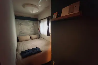 a small bedroom with a bed in a room at TOE LIBRARY Tokyo Asakusa in Tokyo