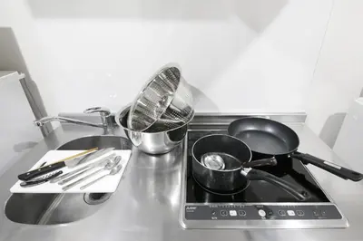 a kitchen counter with pots and pans on a stove at \u30a2\u30ea\u30a2\u66f3\u821f in Tokyo