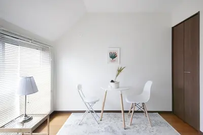 a white dining room with a table and two chairs at \u30a2\u30ea\u30a2\u66f3\u821f in Tokyo