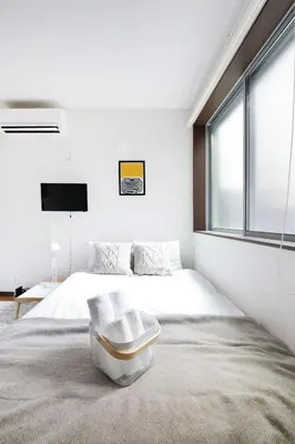 a bedroom with a large bed and a window at \u30a2\u30ea\u30a2\u66f3\u821f in Tokyo