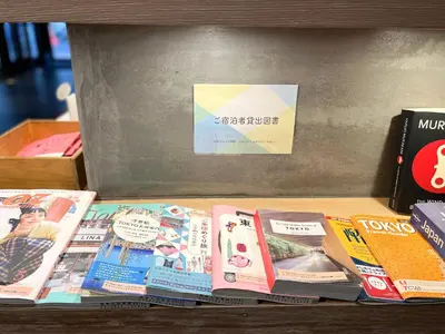 a pile of books sitting on a shelf at Asakusa Kokono Club Hotel in Tokyo
