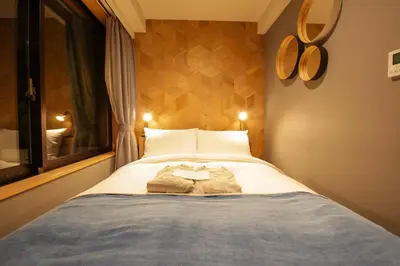 a bedroom with a bed with two towels on it at Asakusa Kokono Club Hotel in Tokyo