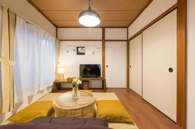 a living room with a table and a tv at Yoshinaga heights in Tokyo