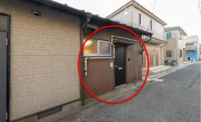 a red circle next to a building with a door at Yoshinaga heights in Tokyo