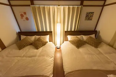 two beds sitting next to each other in a bedroom at Yoshinaga heights in Tokyo