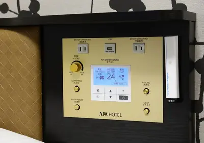 a digital clock on a wall in a room at APA Hotel Akihabara Ekikita in Tokyo