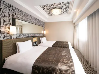 a hotel room with two beds and a mirror at APA Hotel Akihabara Ekikita in Tokyo
