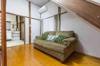 a living room with a brown couch in a room at Samurai House - Large Family House, West Shinjuku in Tokyo