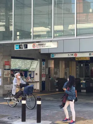 a man riding a bike in front of a building at Samurai House - Large Family House, West Shinjuku in Tokyo