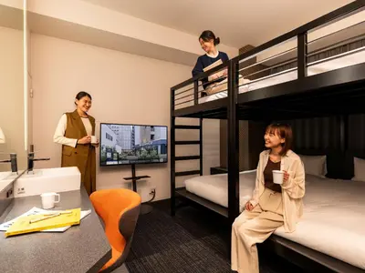 three women standing in a room with bunk beds at sequence SUIDOBASHI - Tokyo in Tokyo