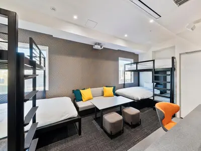 a dorm room with bunk beds and a table at sequence SUIDOBASHI - Tokyo in Tokyo