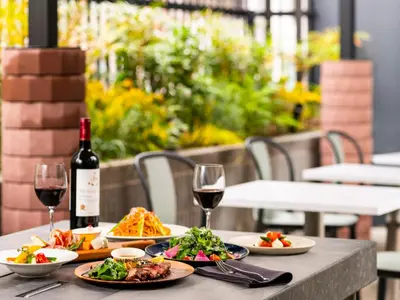 a table with plates of food and a bottle of wine at sequence SUIDOBASHI - Tokyo in Tokyo