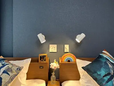 a bedroom with a bed with a rainbow on the wall at nestay villa tokyo akihabara in Tokyo