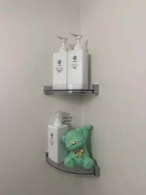 a shelf with three bottles and a green teddy bear at nestay villa tokyo akihabara in Tokyo
