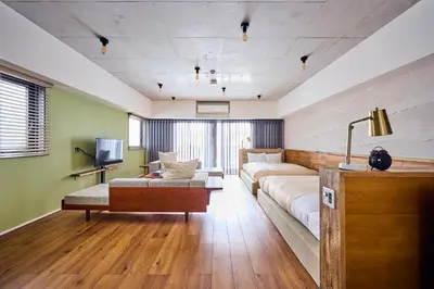 a living room with a couch and a tv at Hotel Vintage Tokyo Kagurazaka in Tokyo
