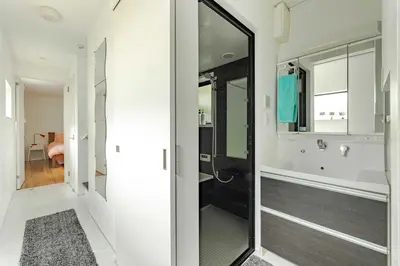a bathroom with a walk in shower and a mirror at Pencil House - 10 mins walk to Shinjuku in Tokyo