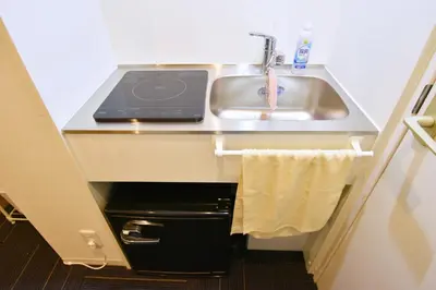 a kitchen with a sink and a laptop on it at REGALO Shibaura - Vacation STAY 87447 in Tokyo