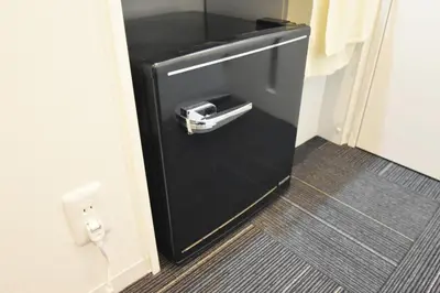 a black refrigerator with its door open in a room at REGALO Shibaura - Vacation STAY 87447 in Tokyo