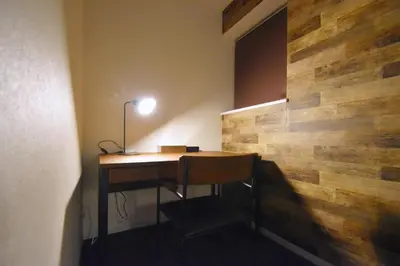 a desk in a room with a wooden wall at REGALO Shibaura - Vacation STAY 88351 in Tokyo
