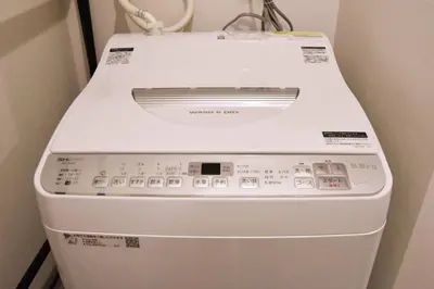 a white washing machine sitting in a room at REGALO Shibaura - Vacation STAY 88351 in Tokyo