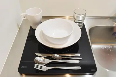 a plate and cutlery on a tray next to a sink at REGALO Shibaura - Vacation STAY 88351 in Tokyo