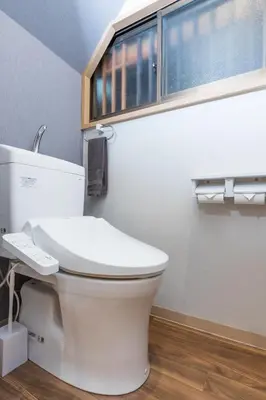 a white toilet in a bathroom with a window at Mita Guest House by Tranova in Tokyo