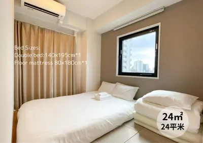 a bedroom with a bed and a window at The Light Inn Tokyo in Tokyo