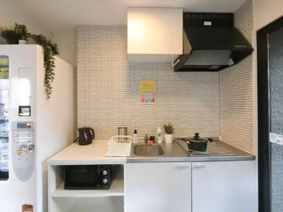 a small kitchen with a sink and a microwave at The Light Inn Tokyo in Tokyo