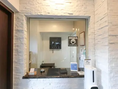 a mirror in a room with a desk and a laptop at The Light Inn Tokyo in Tokyo