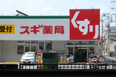 a car is parked in front of a store at The Light Inn Tokyo in Tokyo