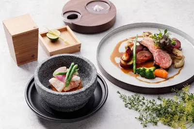 a table with two plates of food and a bowl of food at AC Hotel by Marriott Tokyo Ginza in Tokyo