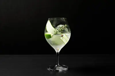a glass with a drink with a lime in it at AC Hotel by Marriott Tokyo Ginza in Tokyo