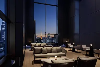 a lobby with couches and tables and a view of a city at AC Hotel by Marriott Tokyo Ginza in Tokyo